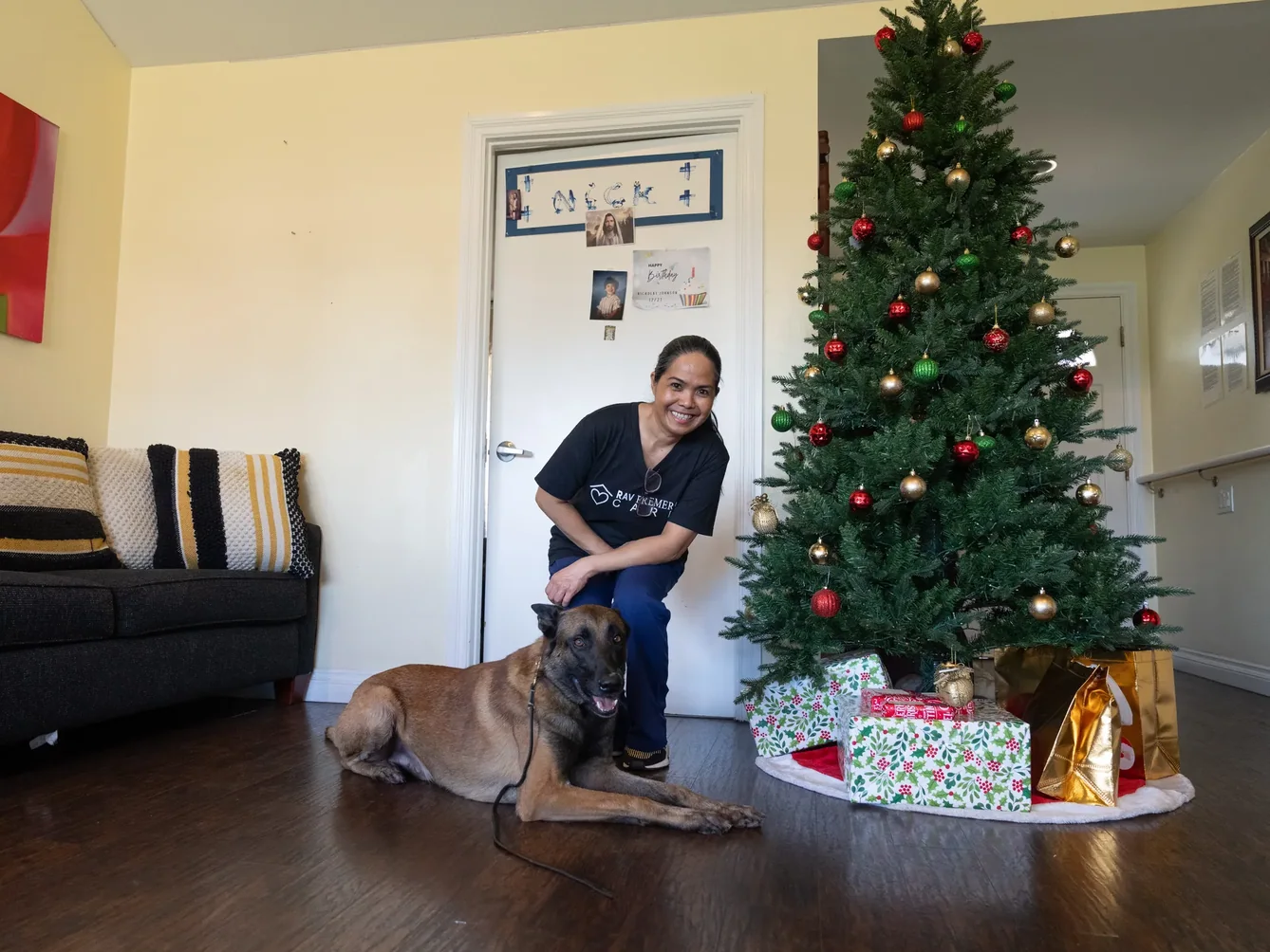 Caregiver with therapy dog in festive home setting during the holidays