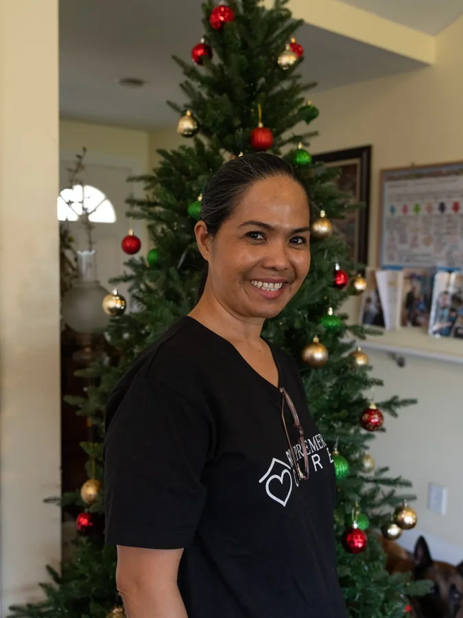 Professional caregiver smiling in home care facility during holiday season